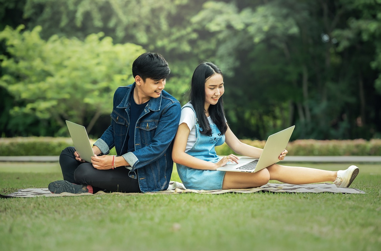 image of two teenager sitting with laptops - tips for finding your first job