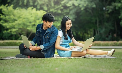 image of two teenager sitting with laptops - tips for finding your first job